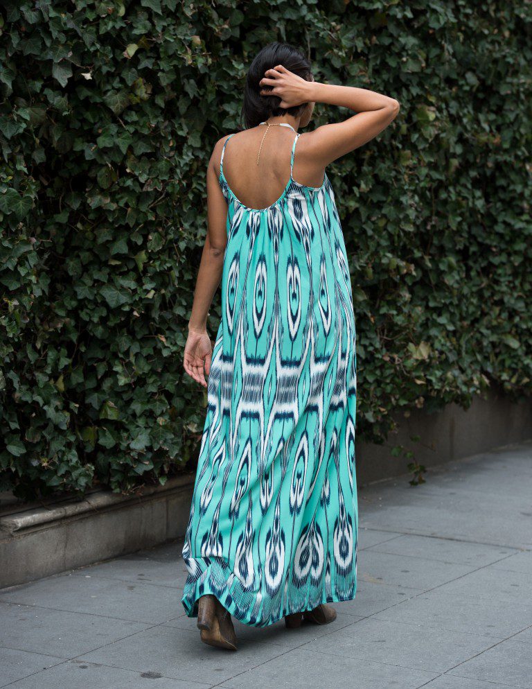 Woman in teal ikat maxi dress.