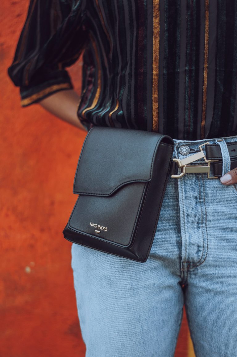 Black belt bag on denim jeans.