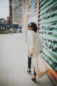 Woman walking with large tote bag.