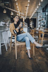 Woman in cafe, enjoying coffee.